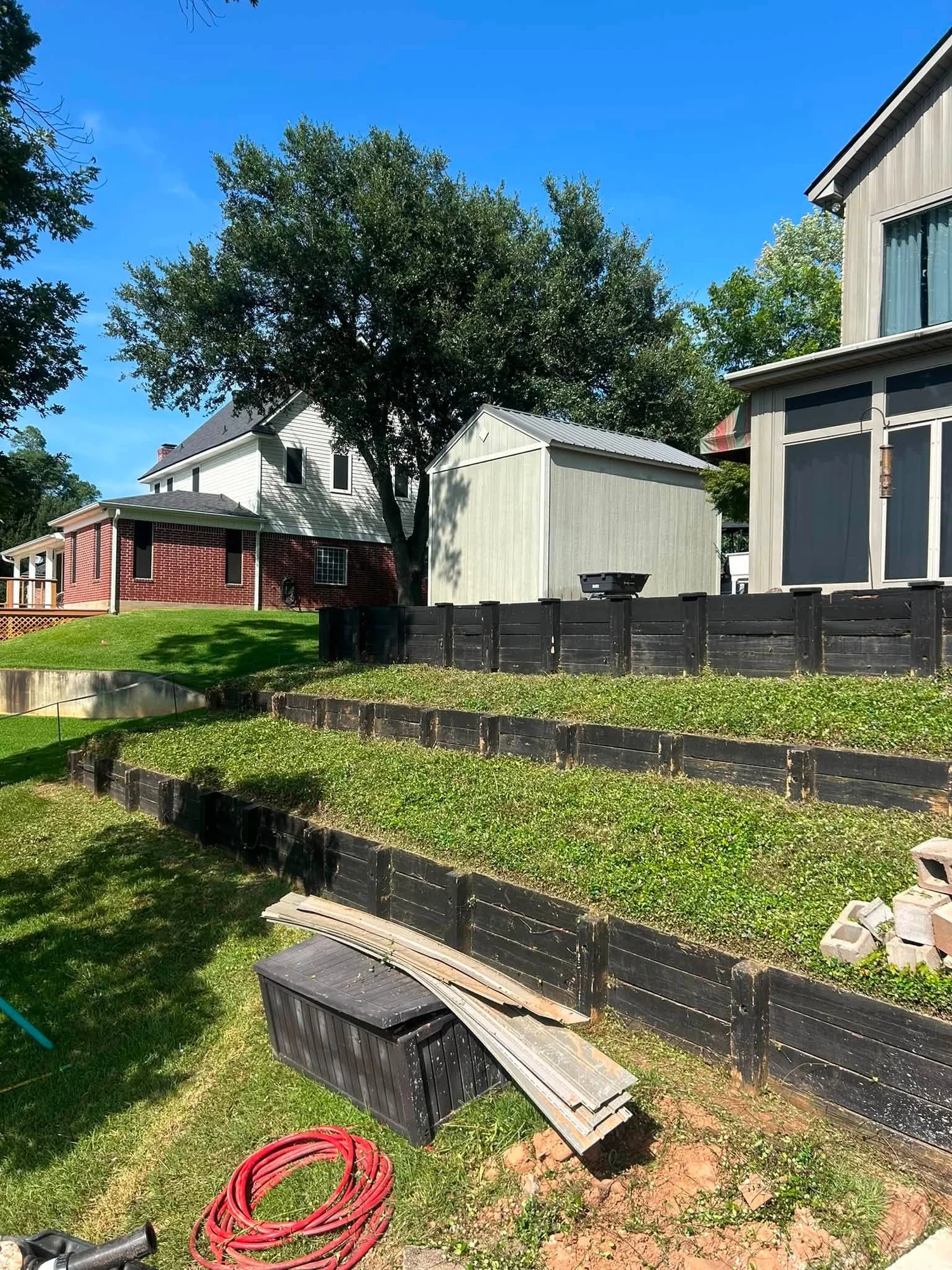 Terraced timber retaining walls on a sloped property