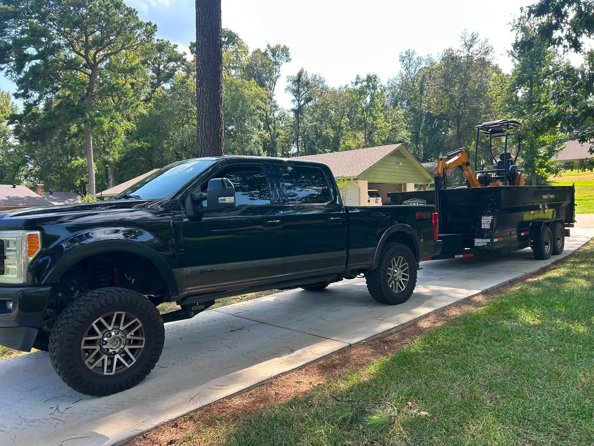 Work truck and hauling trailer carrying White Way Industries equipment