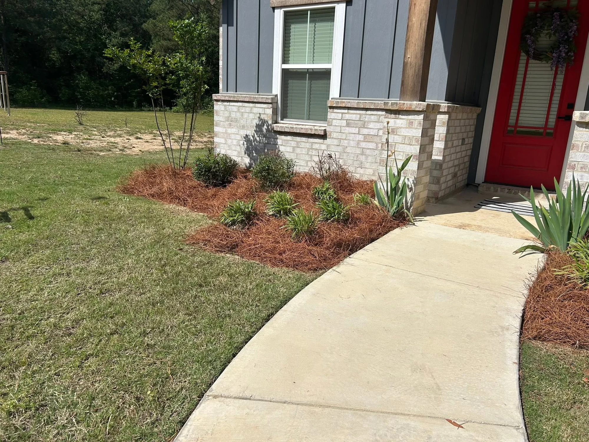 Completed front-entry landscape beds installed by White Way Industries