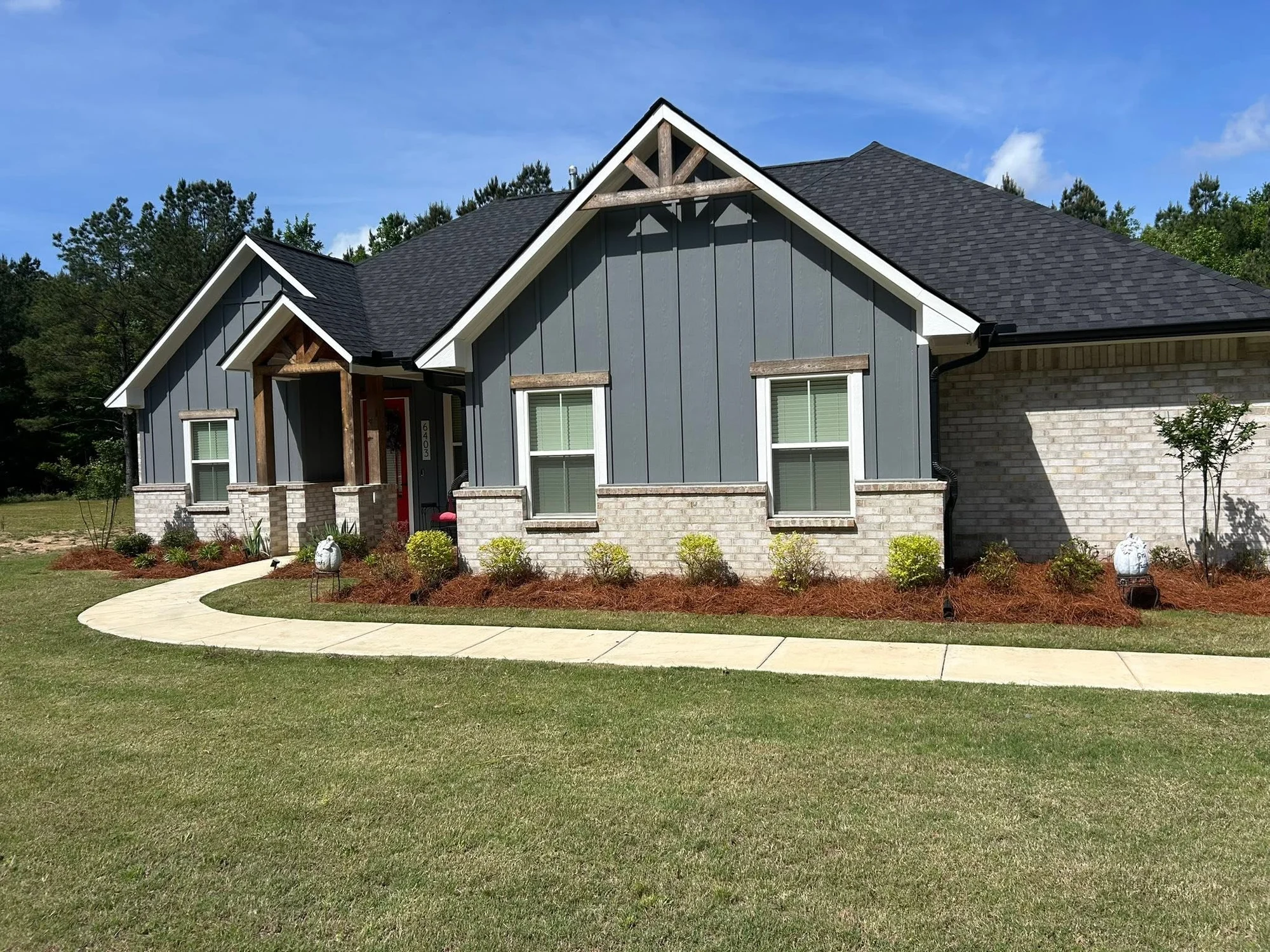 Finished front-yard landscaping and fresh planting beds